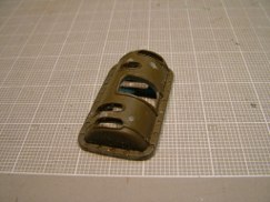 On several earlier Sherman builds, Ethan had robbed the rotor shield off of a 1/18th scale 21rst Century Toy's Sherman, and scabbed it onto the Tamiya turret with good success. Armed with "Modeling the US Army M4 (75mm) Sherman Medium Tank" by Steven Zaloga (Osprey Publishing) I thought I would to tackle the necessary modifications to make my M4A3 as accurate as I reasonably could. Fortunate for me Ethan had an extra 1/18th scale rotor shield he was willing to share.The 21rst Century Toys Sherman has the earlier style M34A1 rotor shield with a flange all the way around it's perimeter, but what I needed to model was the later E5721 configuration without the flange. Because of it's smaller scale the part would also need to be "scaled up" to look correct.