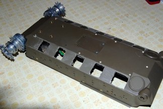 The process starts by taking the Pershing lower hull and backdating it to a form that would have fit the VVSS or HVSS suspension.  I have seen some drawings that indicate piers on each side adapted as necessary to  the approriate suspension type.  Using my motor tool, all the Pershing torsion bar mounts are removed and a cover plate is shaped from .60 plastic card.