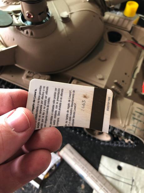 I used an old credit card as it seemed to ironically be the exact shape of the lid.